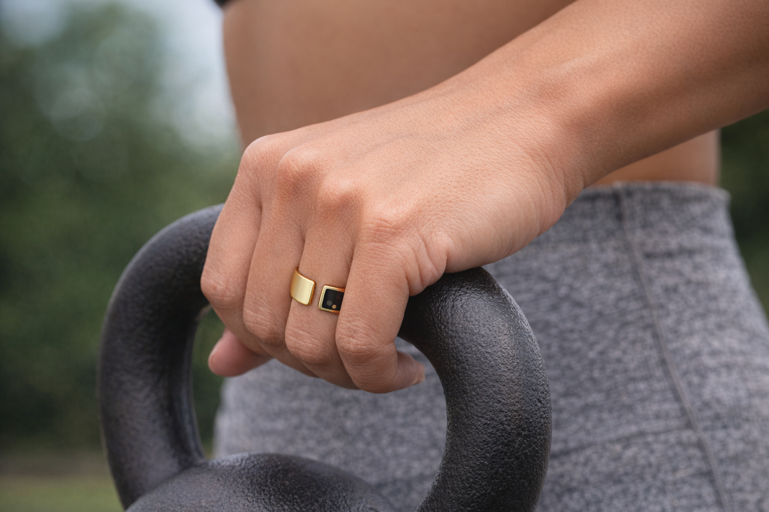 Close-up of the Movano Evie Ring worn during a kettlebell workout