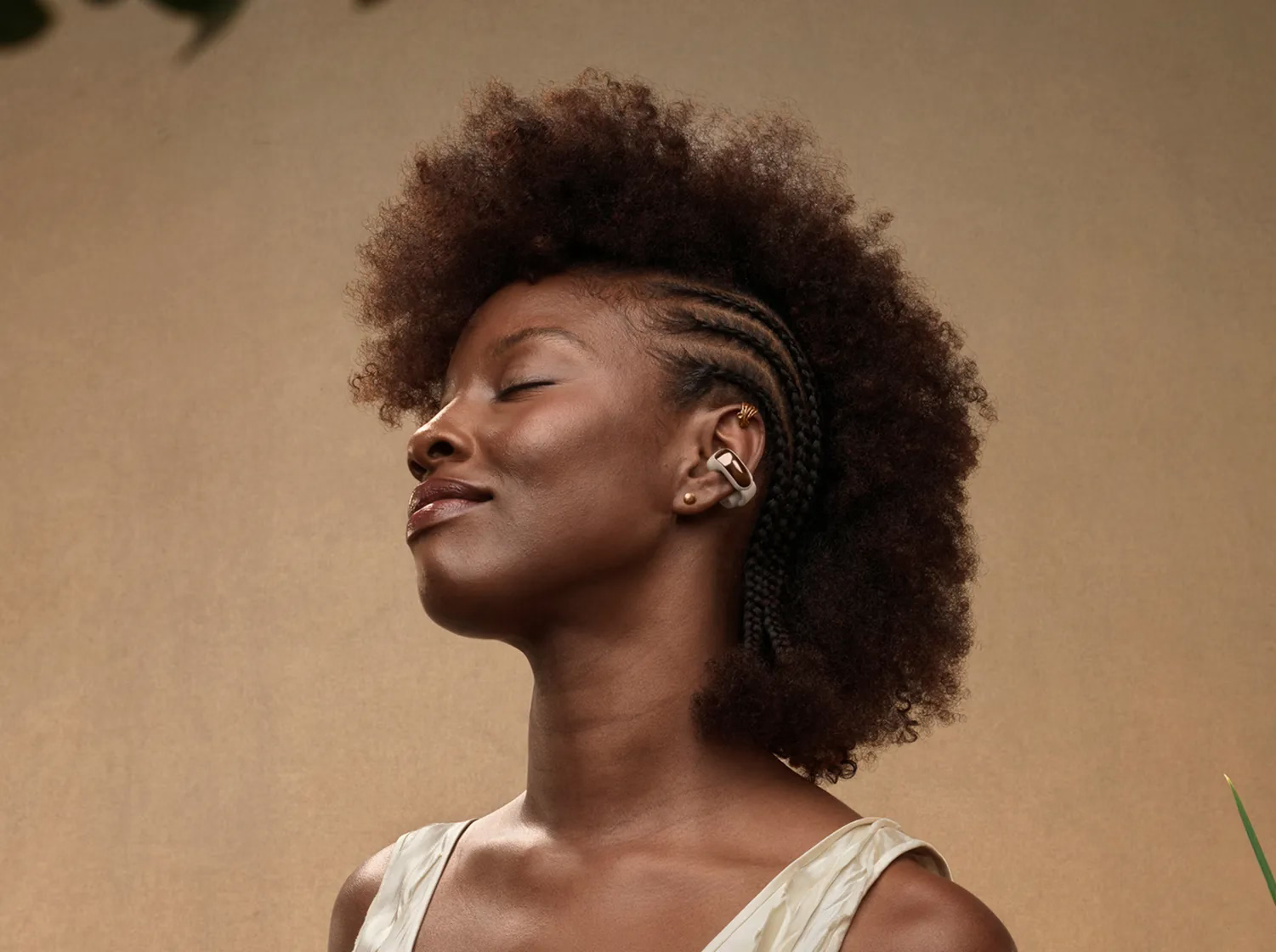 Woman wearing a Bose Ultra Open Earbud clipped to her ear