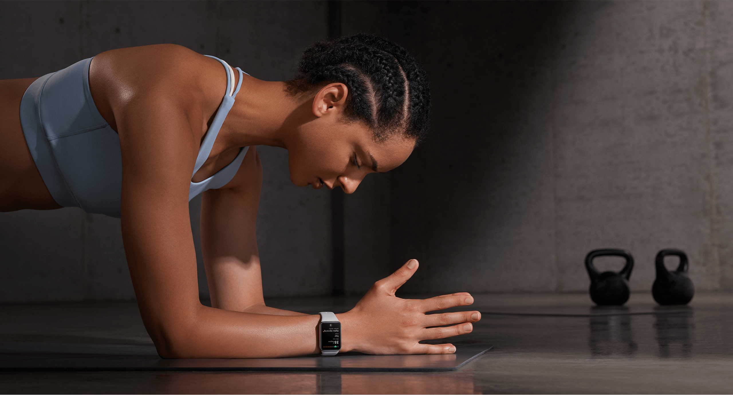Woman doing plank exercise wearing Xiaomi Smart Band 9 Pro in gym setting
