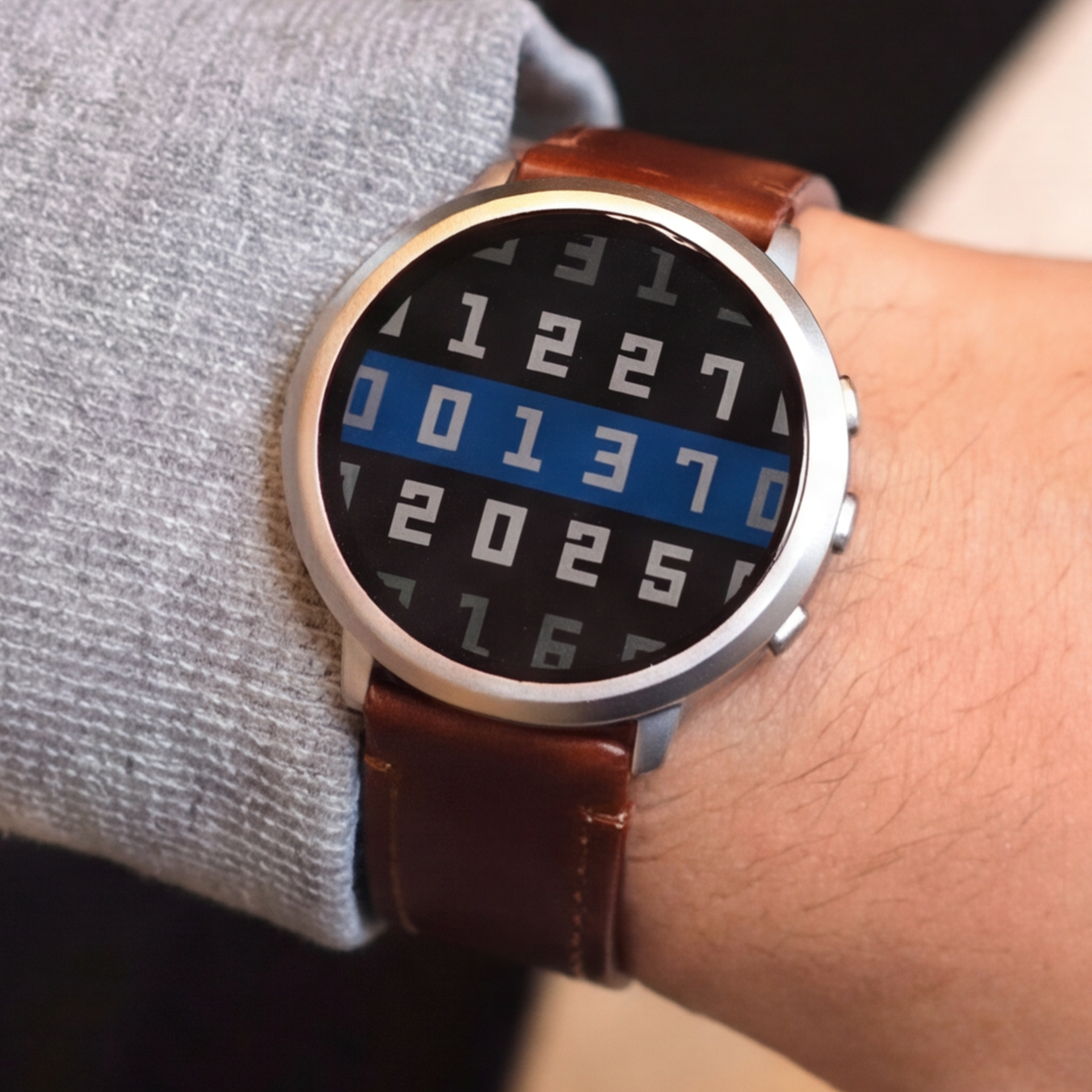 Pebble Round 2 on wrist with brown leather band
