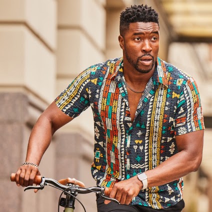 Fitbit Sense 2 worn by man cycling in the city