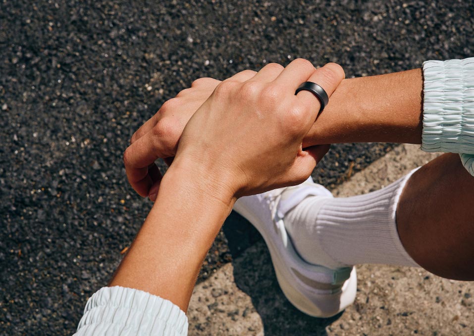 Samsung Galaxy Ring worn while two people hold hands outdoors
