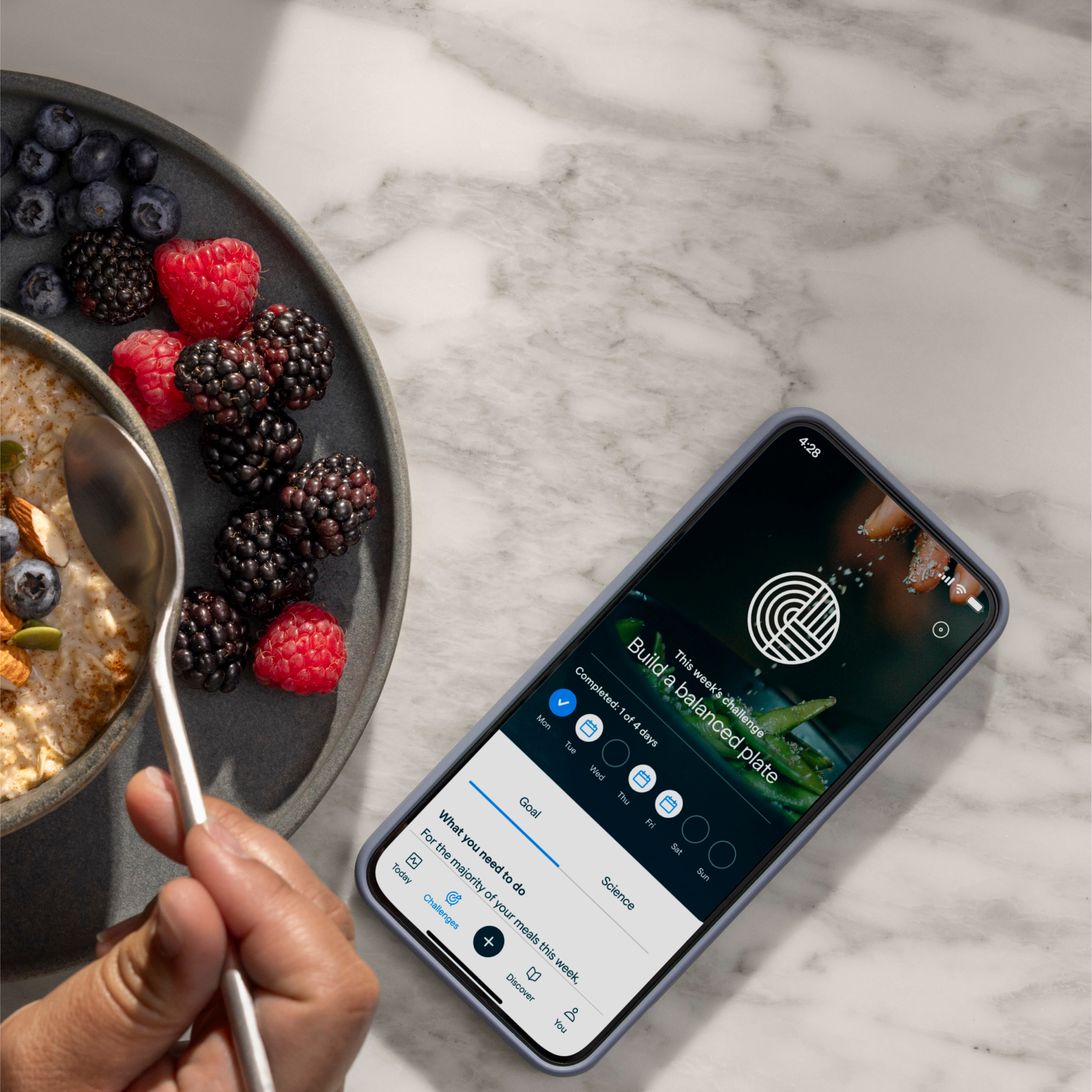 The Lingo app Build a balanced plate weekly challenge shown beside a bowl of oatmeal and berries